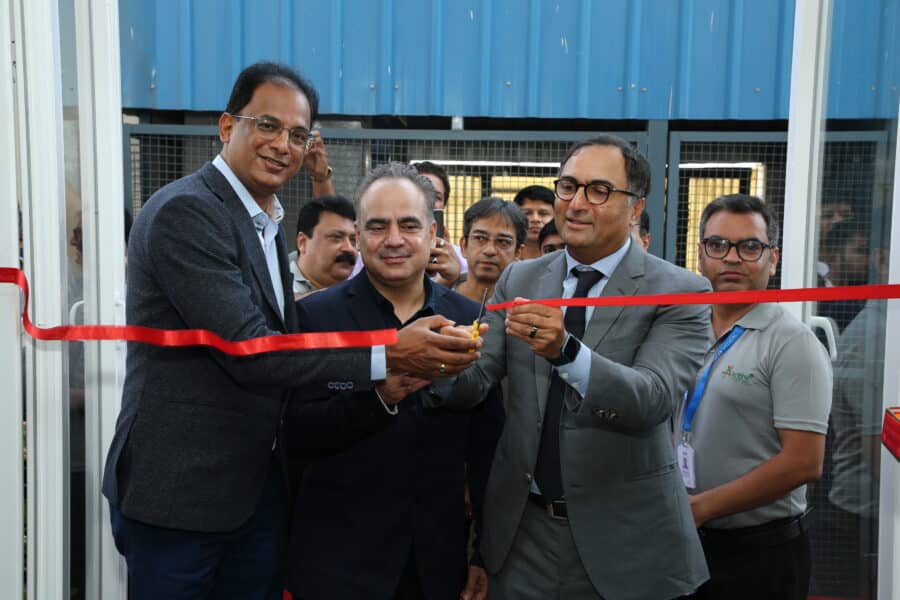 Executives ribbon cutting of new customer experience center in India